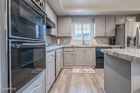 a kitchen with cabinets and stainless steel appliances