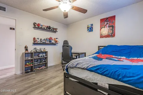 a spacious bedroom with a bed and a chandelier