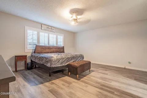 a view of swimming pool with outdoor seating and house in the background