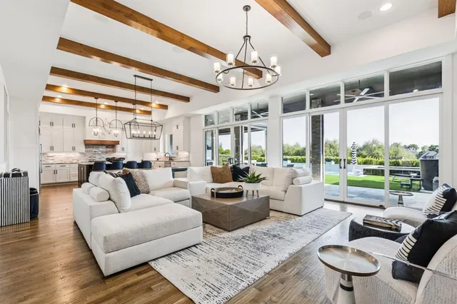 a living room with furniture or kitchen and a chandelier