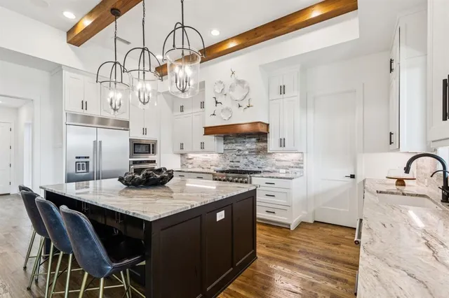 a kitchen with granite countertop a sink and cabinets