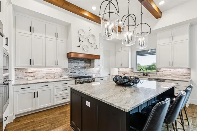 a kitchen with stainless steel appliances granite countertop a sink and cabinets