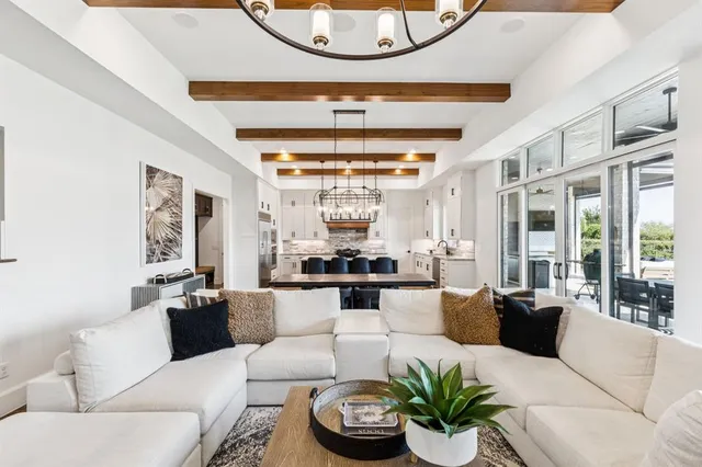a living room with fireplace furniture and a large window