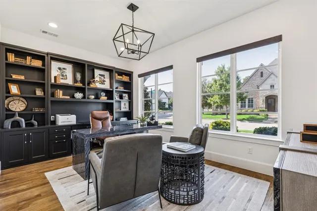 a view of a hallway to a house and wooden floor