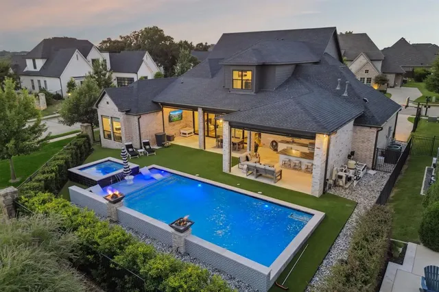 an aerial view of a house with a swimming pool