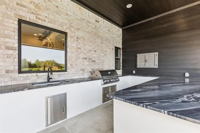a view of a patio with couches chairs dining table and chairs with wooden floor