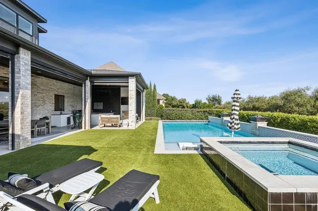 a view of a house with swimming pool and sitting area
