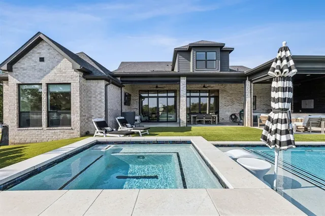 a view of a house with pool and chairs