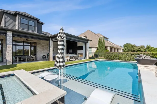 a view of a house with swimming pool and porch