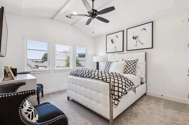 a bedroom with furniture and a chandelier