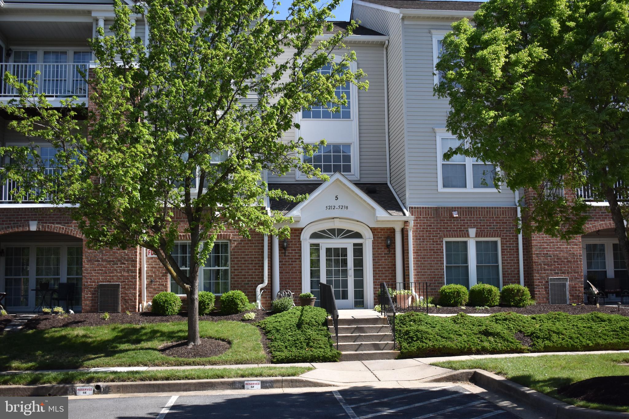 5236 Millfield Road, Unit 5236 Baltimore, MD 21237 - Photo 1 of 54 a front view of a house with a yard and potted plants