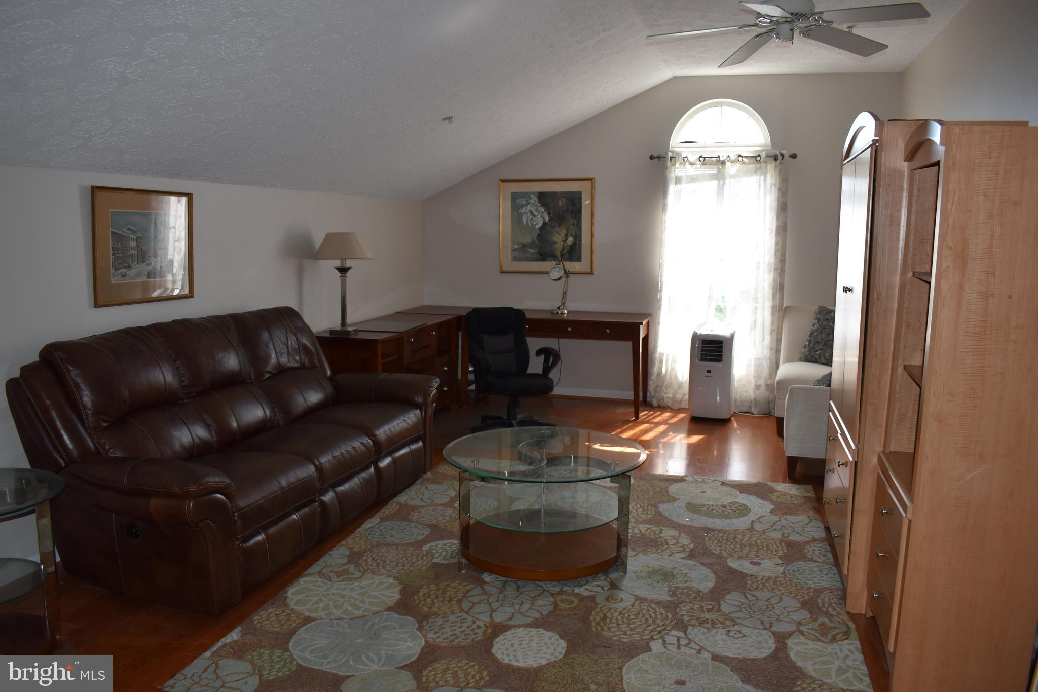 5236 Millfield Road, Unit 5236 Baltimore, MD 21237 - Photo 13 of 54 a living room with furniture and a window