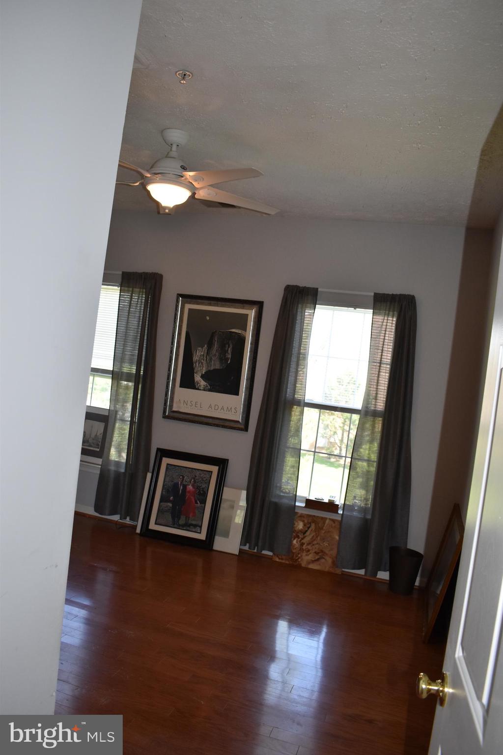 5236 Millfield Road, Unit 5236 Baltimore, MD 21237 - Photo 29 of 54 a view of an empty room with wooden floor and a window