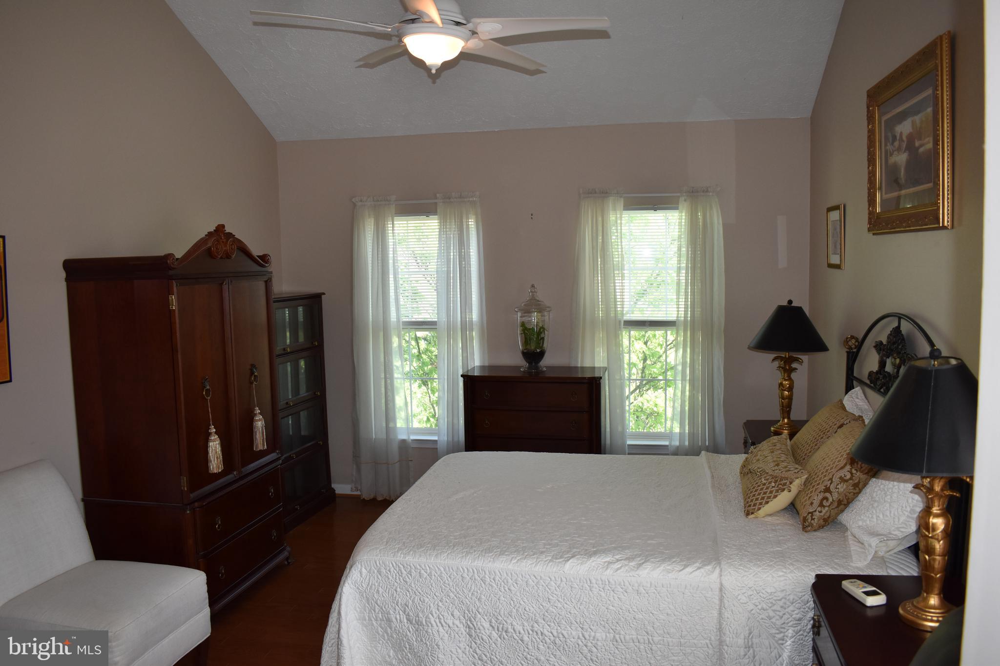 5236 Millfield Road, Unit 5236 Baltimore, MD 21237 - Photo 38 of 54 a bedroom with a bed and a chandelier