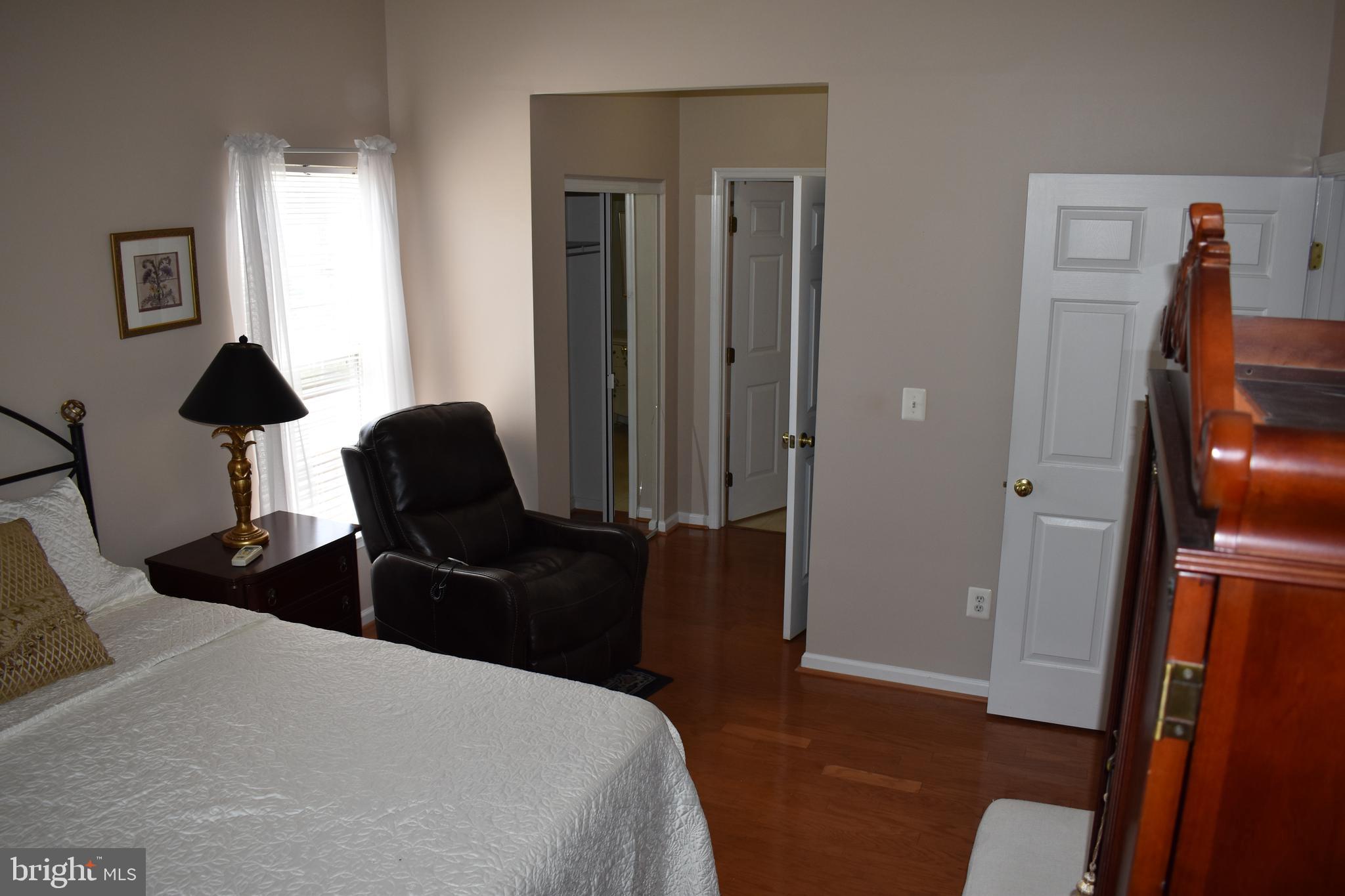 5236 Millfield Road, Unit 5236 Baltimore, MD 21237 - Photo 40 of 54 a bedroom with a bed and wooden floor