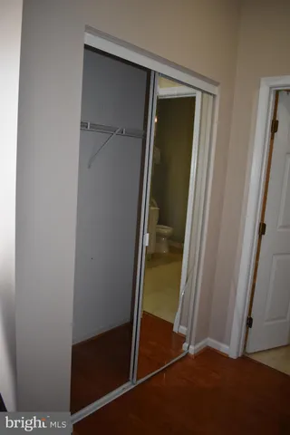 a bathroom with a sink mirror and a toilet
