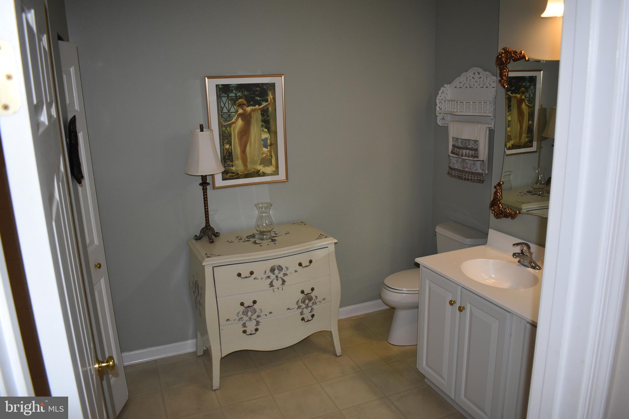 5236 Millfield Road, Unit 5236 Baltimore, MD 21237 - Photo 43 of 54 a bathroom with a toilet sink and mirror