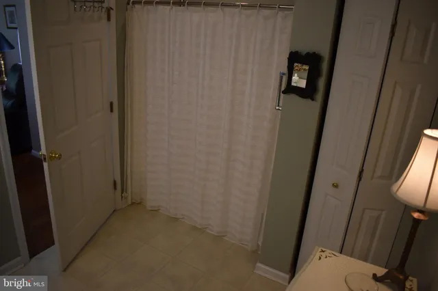 a view of a garden with lawn chairs under an umbrella