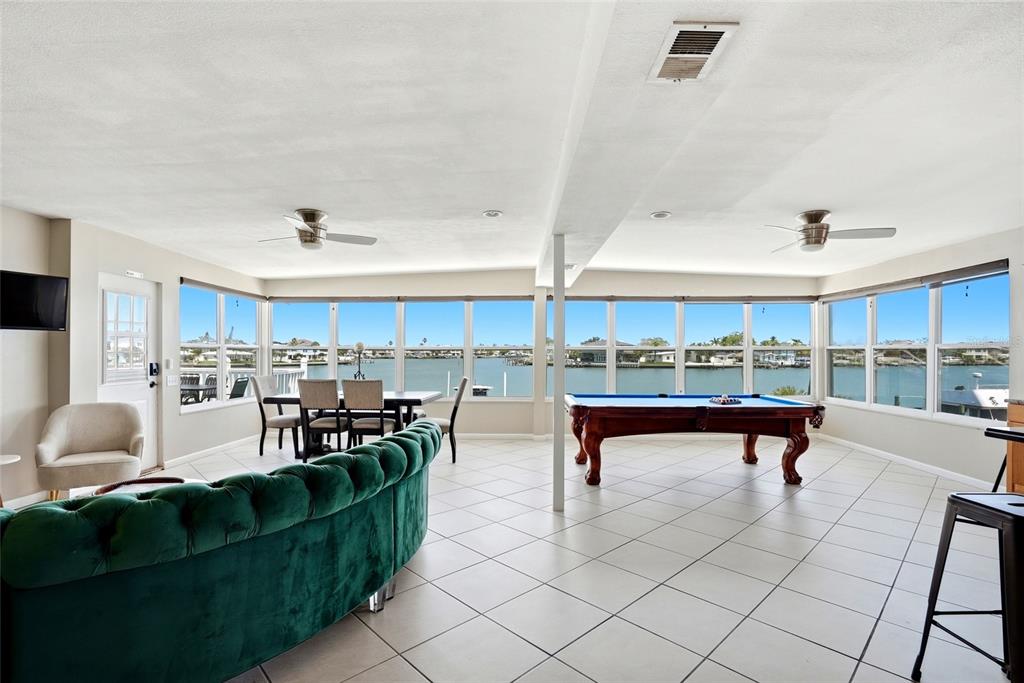 2311 Bay Boulevard Indian Rocks Beach, FL 33785 - Photo 7 of 80 a living room with furniture a table and kitchen view