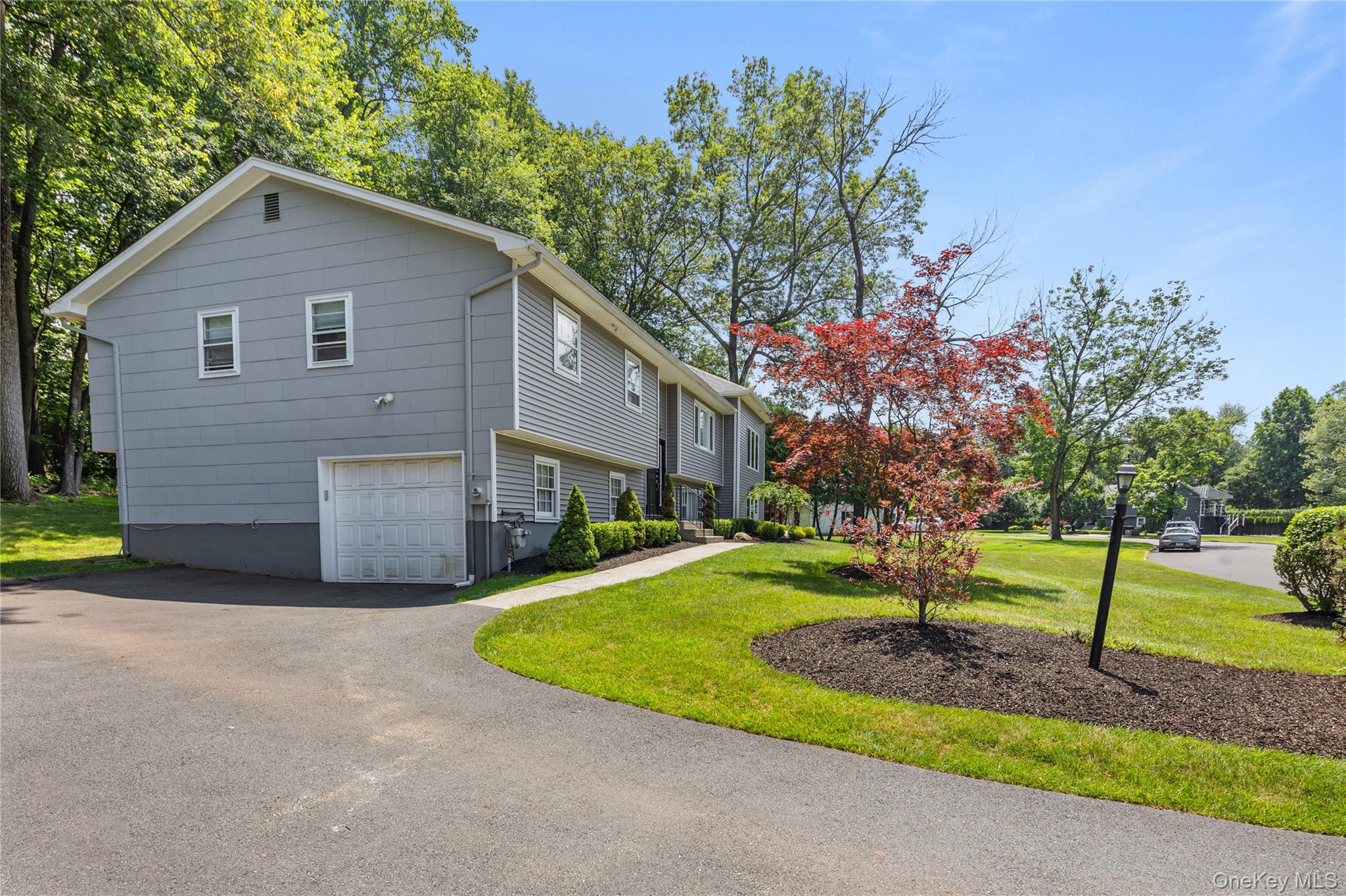 29 Skylark Drive Spring Valley, NY 10977 - Photo 3 of 44 a front view of a house with a yard garage and trees