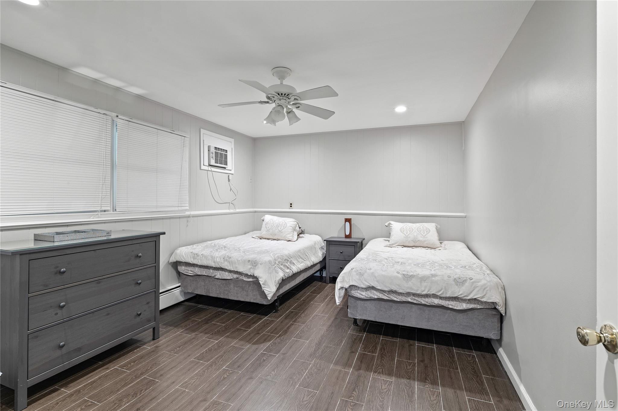 29 Skylark Drive Spring Valley, NY 10977 - Photo 38 of 44 a spacious bedroom with two beds and painting on the wall