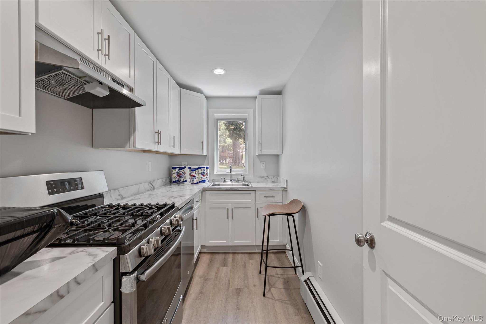 29 Skylark Drive Spring Valley, NY 10977 - Photo 40 of 44 a kitchen with a sink a stove and cabinets