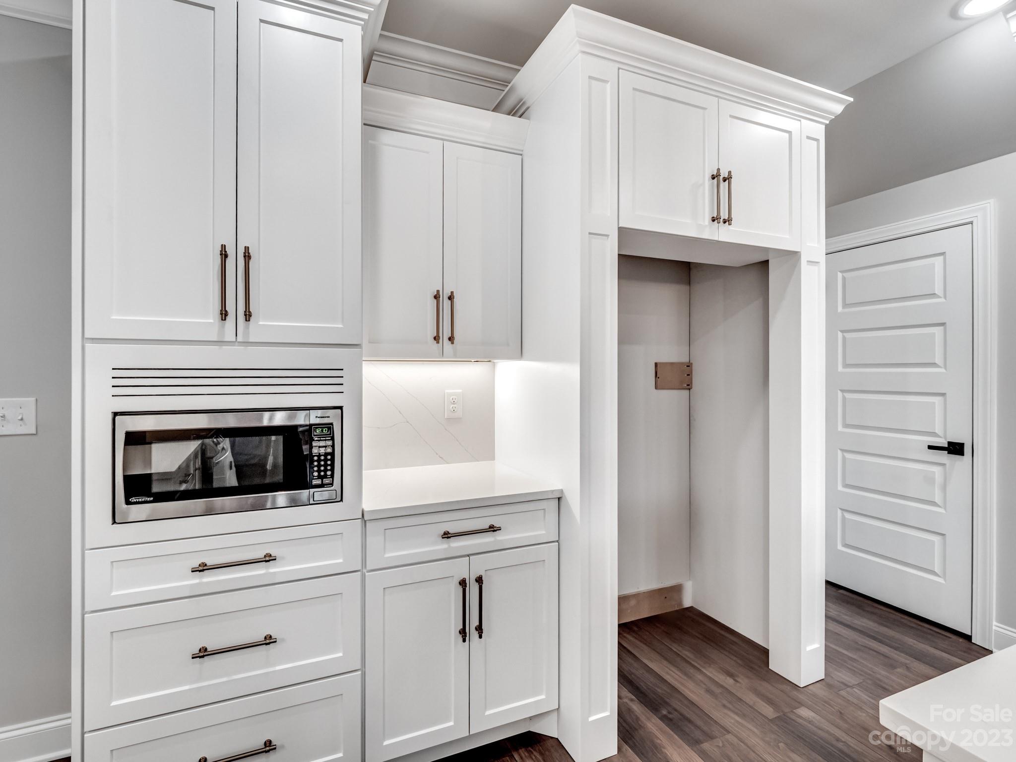 213 9th Street Northeast Conover, NC 28613 - Photo 11 of 38 a kitchen with white cabinets and white appliances