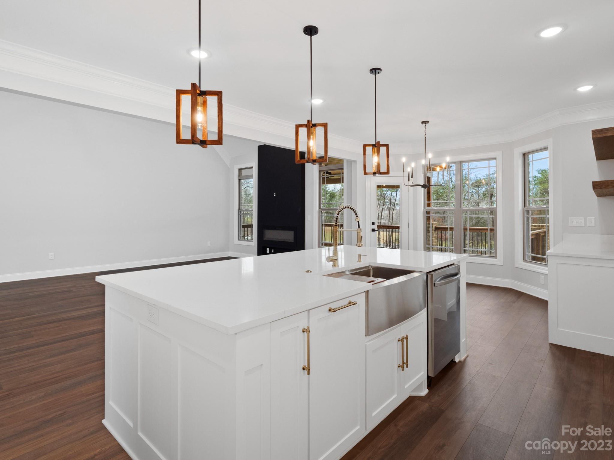 213 9th Street Northeast Conover, NC 28613 - Photo 12 of 38 a kitchen with a stove and a wooden floor