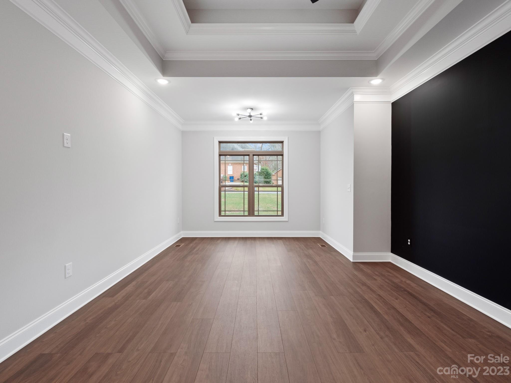 213 9th Street Northeast Conover, NC 28613 - Photo 21 of 38 an empty room with wooden floor and windows