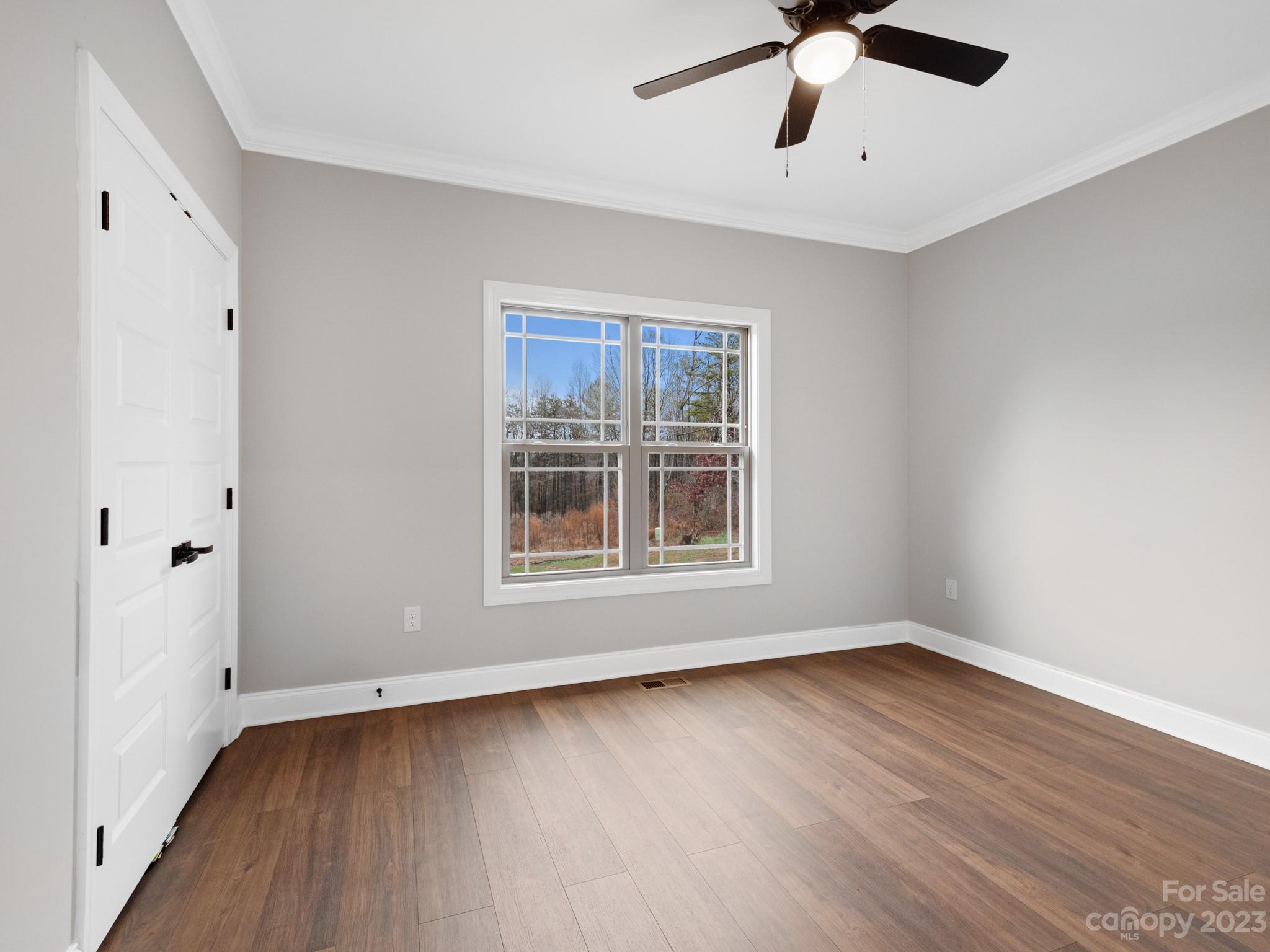 213 9th Street Northeast Conover, NC 28613 - Photo 24 of 38 wooden floor in an empty room with a window