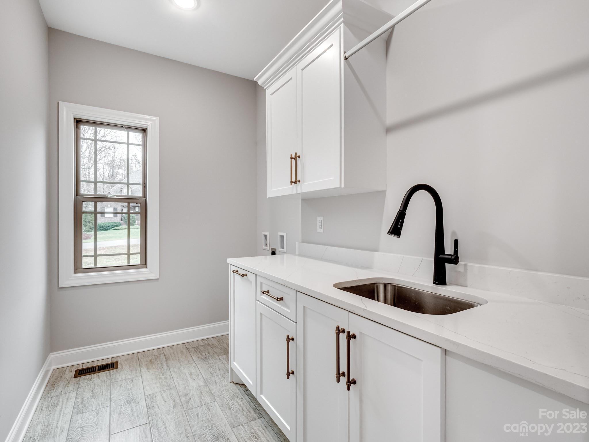 213 9th Street Northeast Conover, NC 28613 - Photo 26 of 38 a kitchen with a sink and cabinets