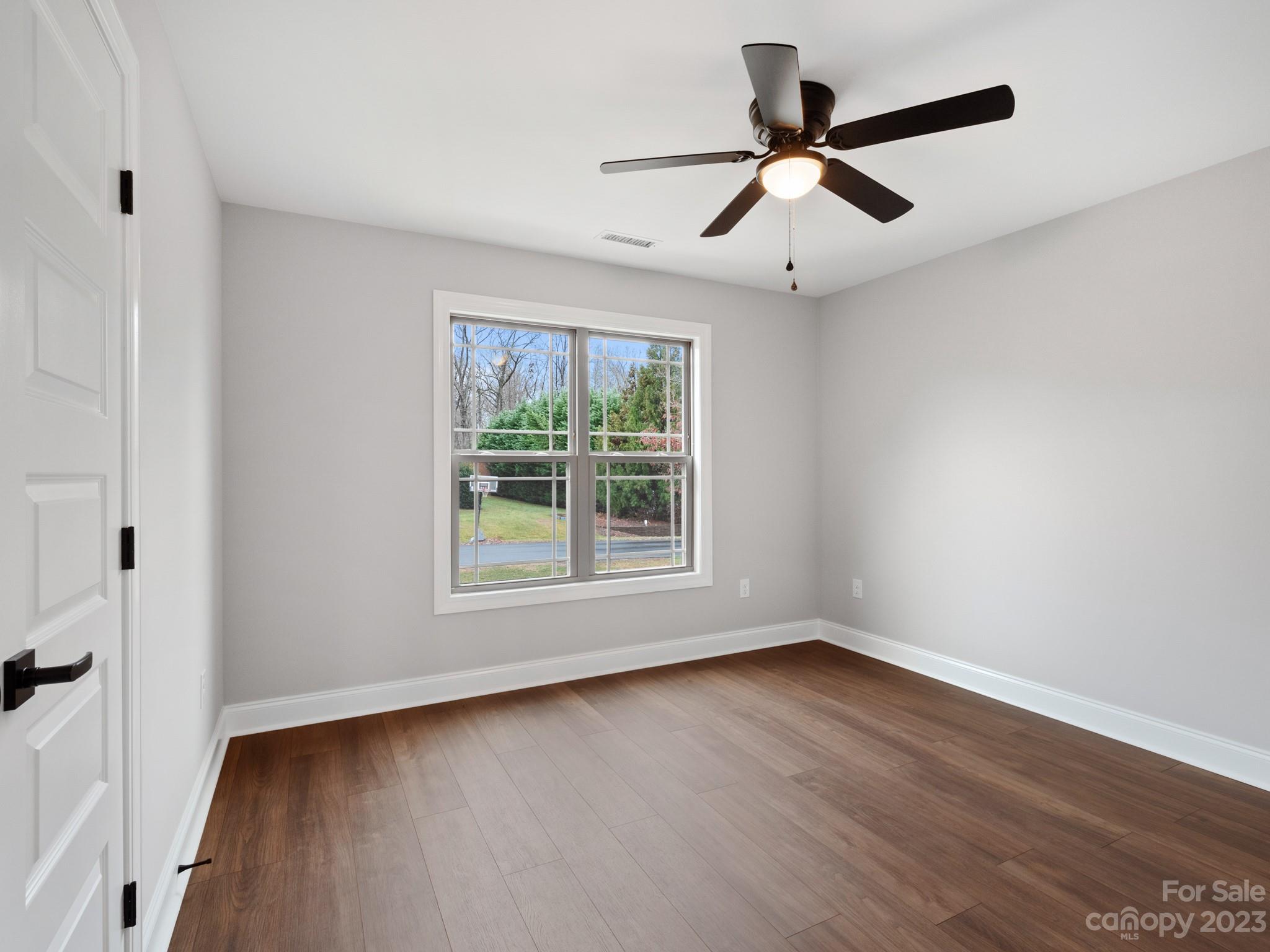 213 9th Street Northeast Conover, NC 28613 - Photo 28 of 38 wooden floor in an empty room with a window