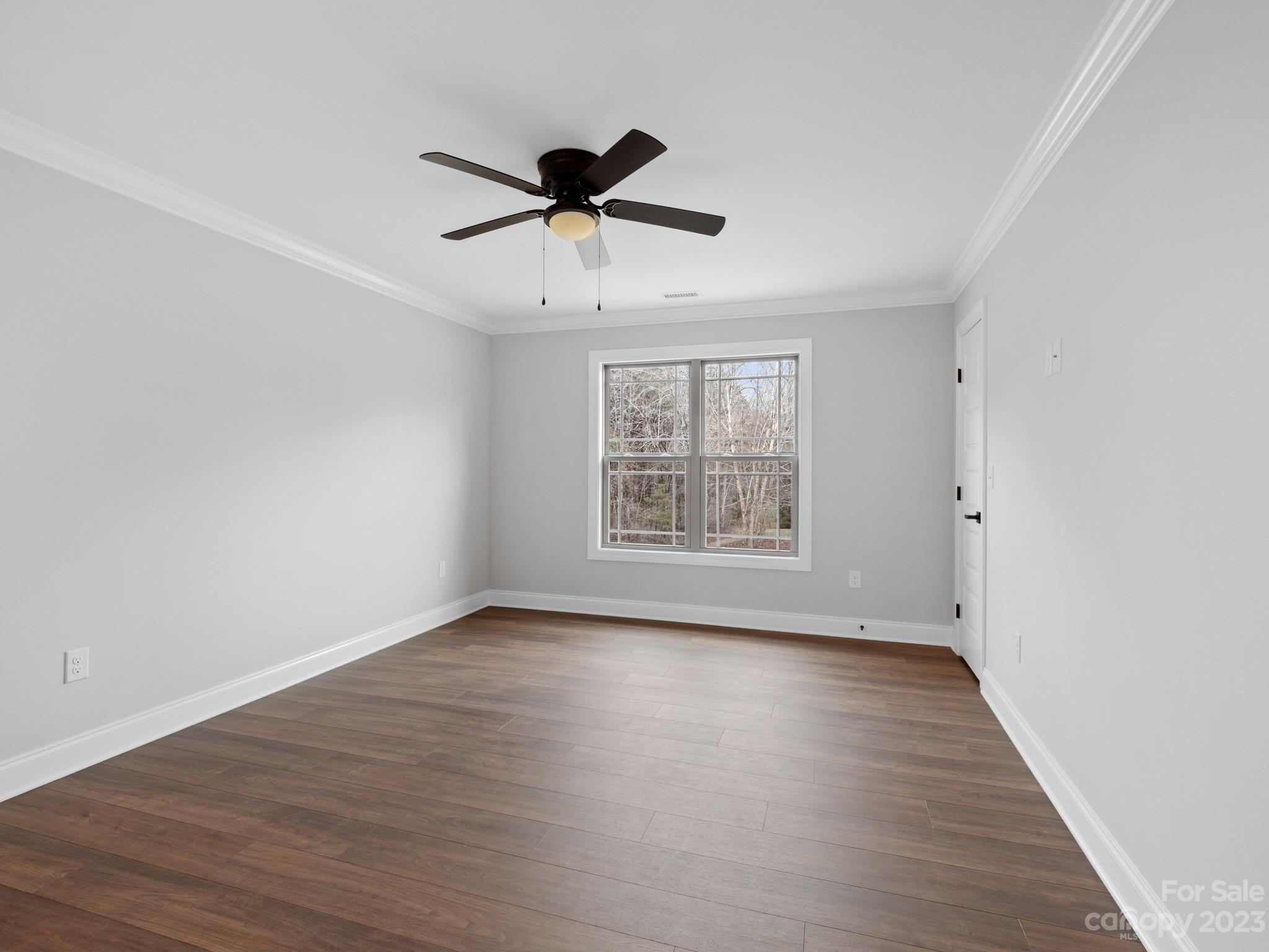 213 9th Street Northeast Conover, NC 28613 - Photo 29 of 38 an empty room with wooden floor fan and windows