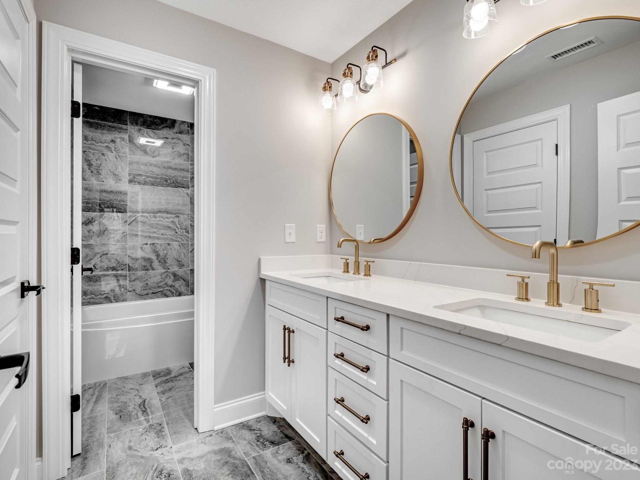213 9th Street Northeast Conover, NC 28613 - Photo 31 of 38 a bathroom with a double vanity sink and a mirror