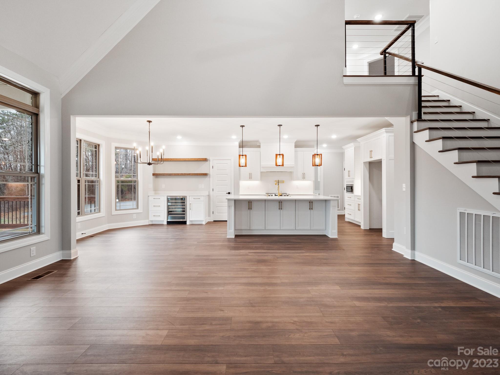 213 9th Street Northeast Conover, NC 28613 - Photo 7 of 38 a view of a kitchen with furniture and wooden floor