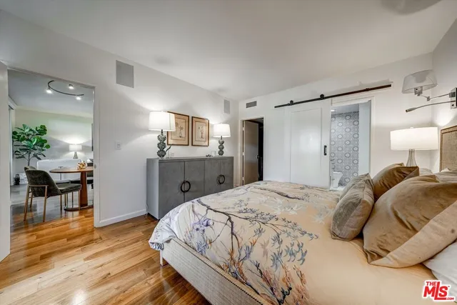 a bedroom with a bed and a view of kitchen