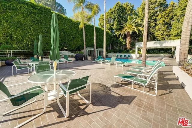 a view of a patio with dining table and chairs with wooden floor and fence