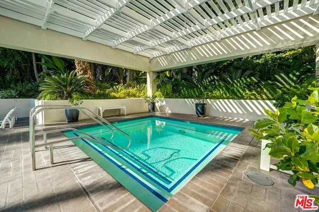 a view of a patio with couches table and chairs with wooden floor and fence