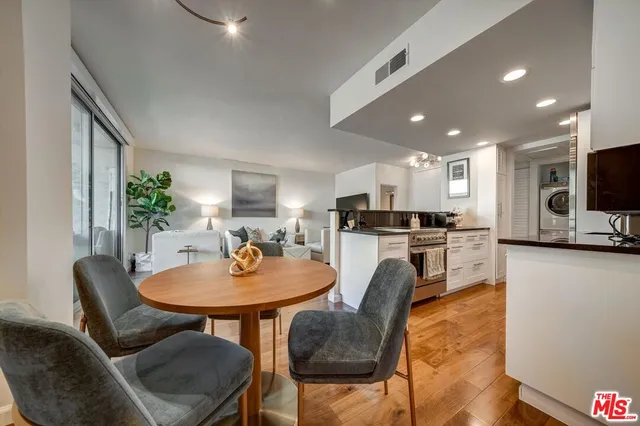 a kitchen with a dining table chairs and microwave