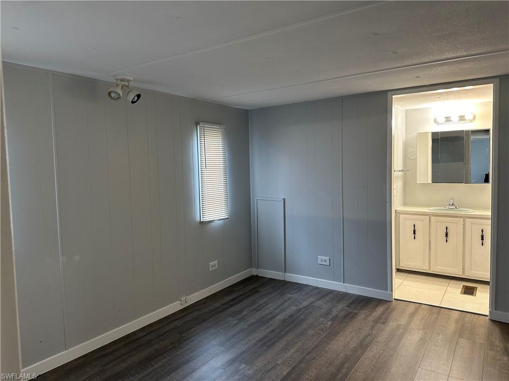 240 Cape Sable Drive Naples, FL 34104 - Photo 12 of 21 a view of an empty room with window and wooden floor