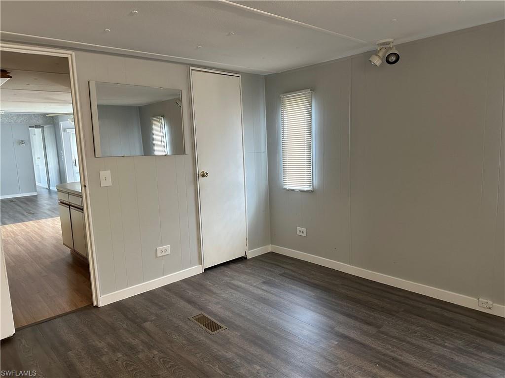 240 Cape Sable Drive Naples, FL 34104 - Photo 13 of 21 a view of an empty room with wooden floor and a window