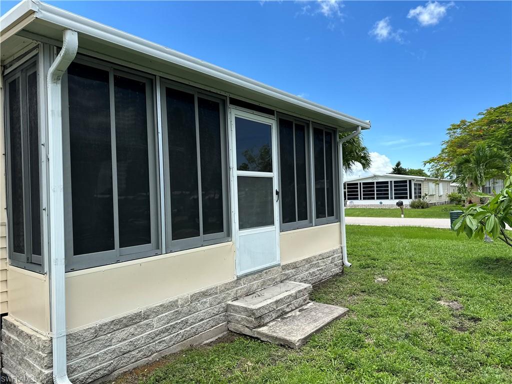 240 Cape Sable Drive Naples, FL 34104 - Photo 17 of 21 a front view of a house with a yard