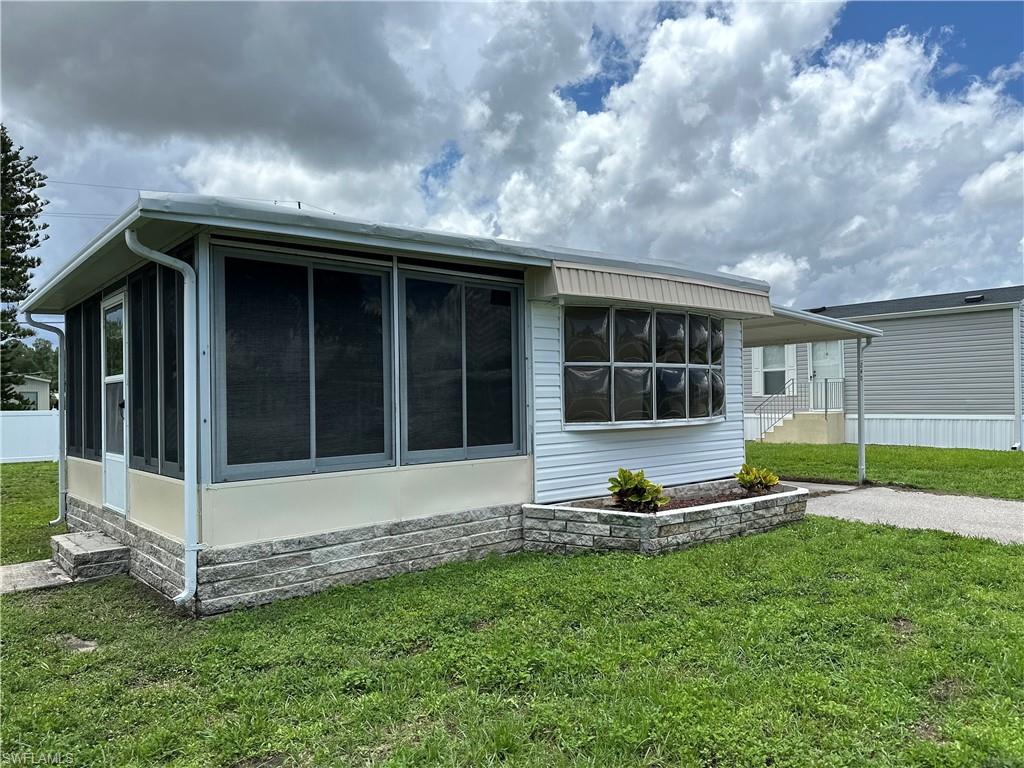 240 Cape Sable Drive Naples, FL 34104 - Photo 18 of 21 a view of an house with backyard space and a garden
