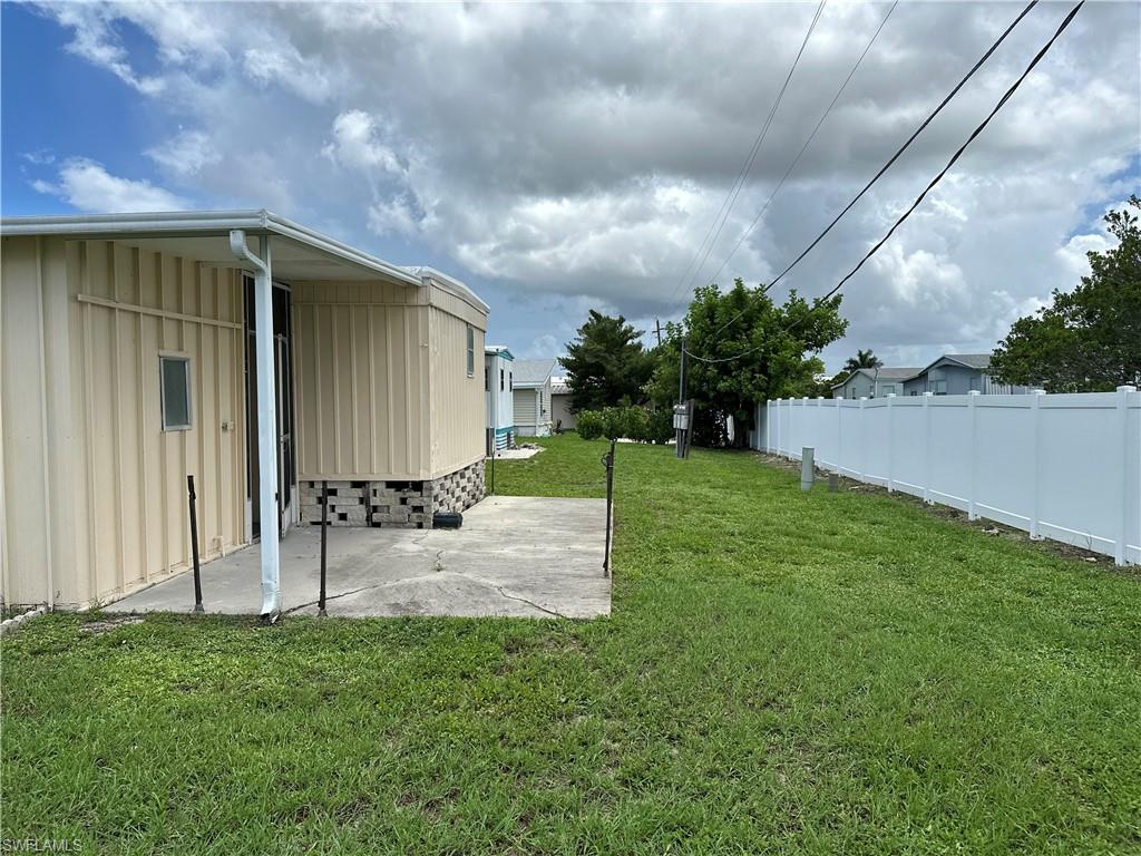 240 Cape Sable Drive Naples, FL 34104 - Photo 20 of 21 a backyard of a house with table and chairs