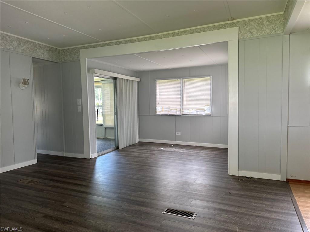 240 Cape Sable Drive Naples, FL 34104 - Photo 5 of 21 an empty room with wooden floor and windows