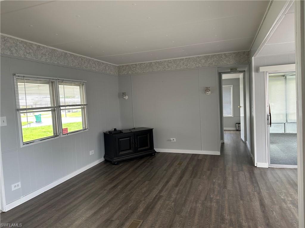 240 Cape Sable Drive Naples, FL 34104 - Photo 9 of 21 wooden floor in an empty room with a window