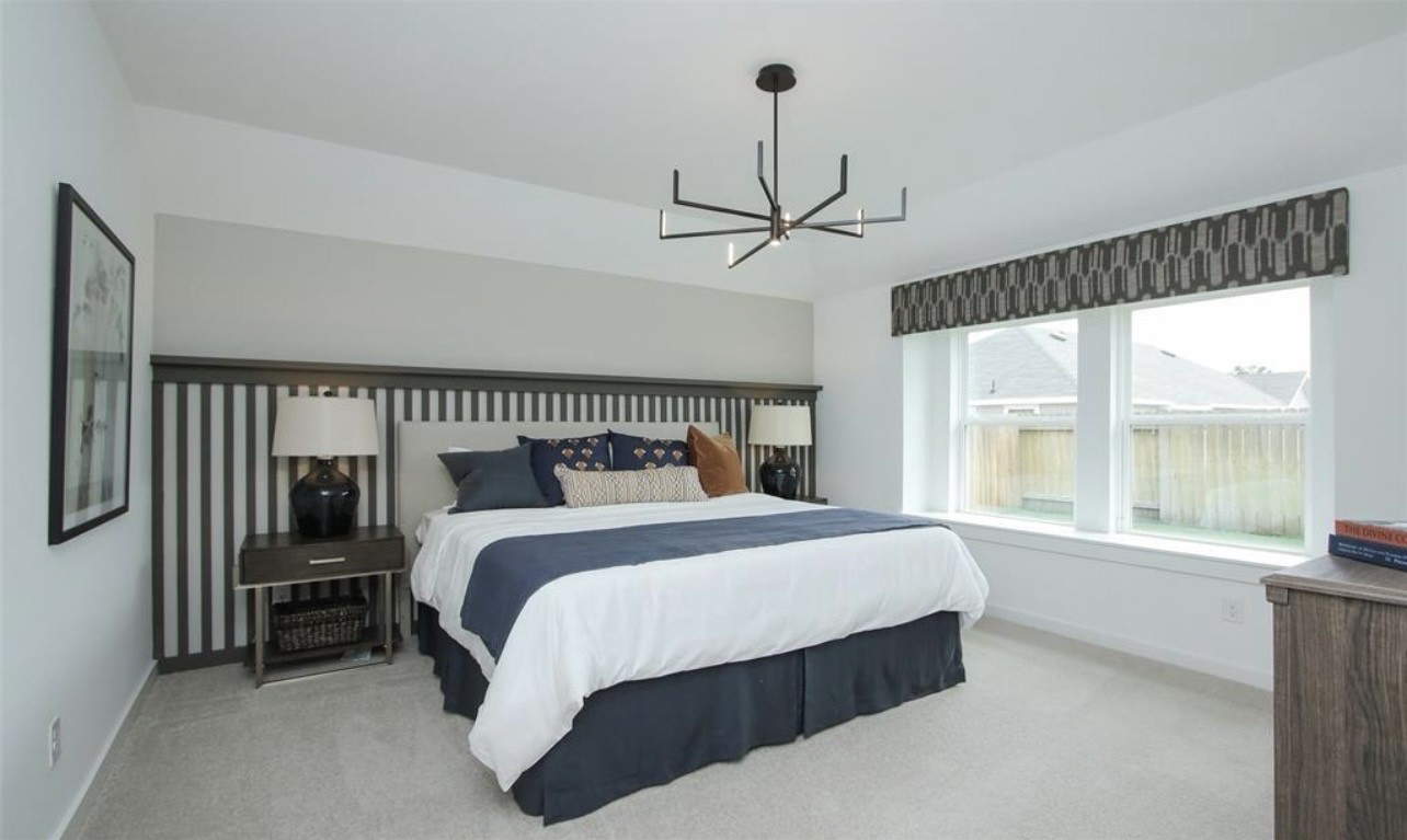 104 Lisa Marie Drive Angleton, TX 77515 - Photo 20 of 33 a bedroom with a large bed and a large window