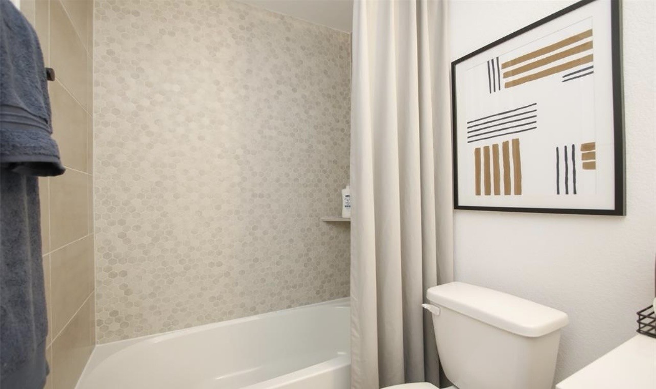 104 Lisa Marie Drive Angleton, TX 77515 - Photo 30 of 33 a white toilet sitting next to a bath tub