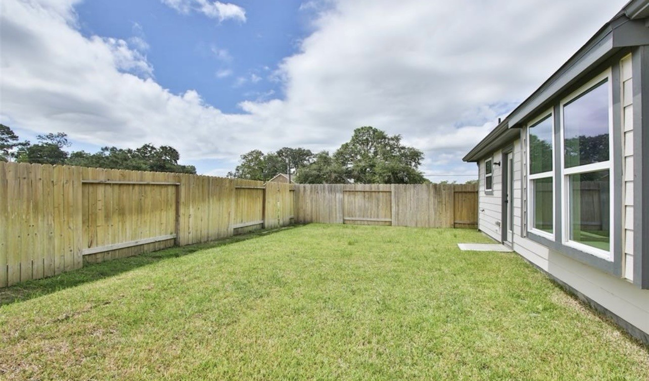 104 Lisa Marie Drive Angleton, TX 77515 - Photo 31 of 33 a view of a backyard with a garden