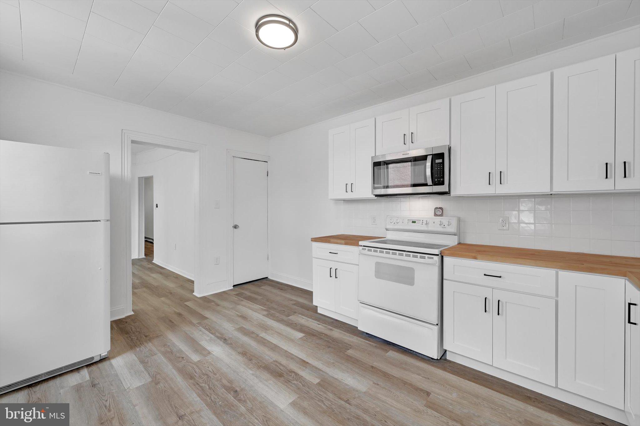 170 South Franklin Street Pottstown, PA 19464 - Photo 13 of 31 a kitchen with granite countertop white cabinets and white appliances